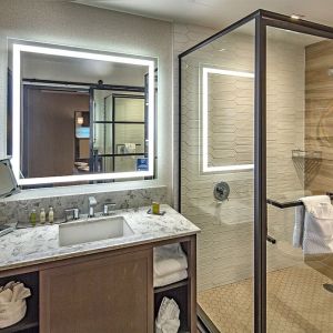 Guest bathroom with shower at DoubleTree By Hilton Modesto.