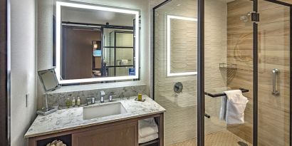 Guest bathroom with shower at DoubleTree By Hilton Modesto.