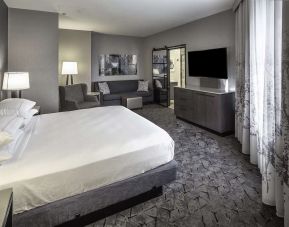 King size bed and sofa in a day use room at DoubleTree By Hilton Modesto.