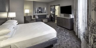 King size bed and sofa in a day use room at DoubleTree By Hilton Modesto.