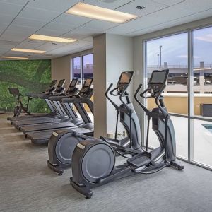 Fitness center with a view of the pool at DoubleTree By Hilton Modesto.