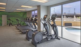 Fitness center with a view of the pool at DoubleTree By Hilton Modesto.