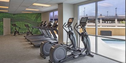 Fitness center with a view of the pool at DoubleTree By Hilton Modesto.