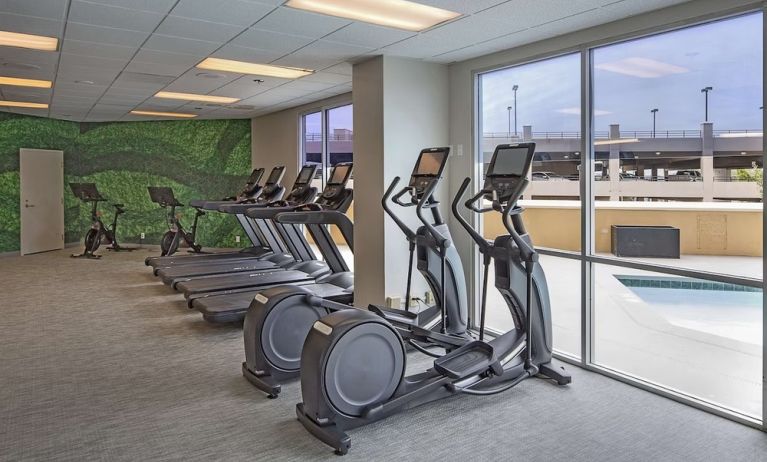 Fitness center with a view of the pool at DoubleTree By Hilton Modesto.