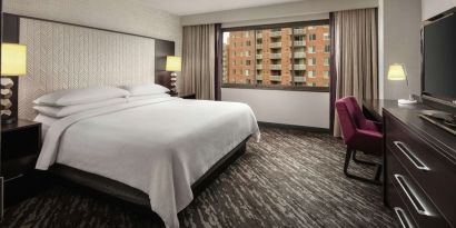 King bedroom with work desk at Embassy Suites By Hilton Crystal City-National Airport.