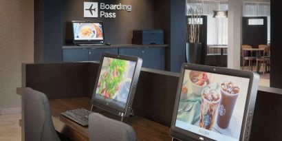 Business center with computers and ergonomic chairs at Sonesta Select Whippany Hanover.