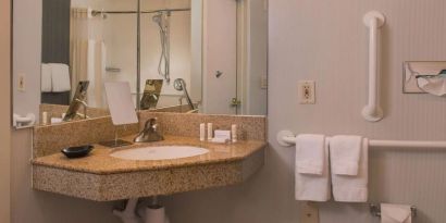 Private guest bathroom with shower and free toiletries at Sonesta Select Columbia.