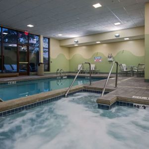 Relaxing indoor pool with lounge chairs at Sonesta Milwaukee West Wauwatosa.