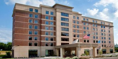 Hotel exterior and parking area at Sonesta Milwaukee West Wauwatosa.
