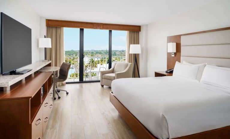 King size bed, work desk and balcony at DoubleTree Beach Resort By Hilton Tampa Bay - North Redington.