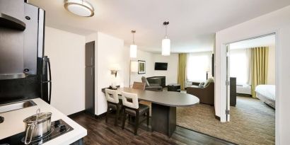 Day use suite with in-room kitchen, living area and private bathroom at Sonesta Simply Suites Plano Frisco.