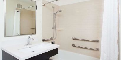 Private guest bathroom with shower at Sonesta Simply Suites Plano Frisco.