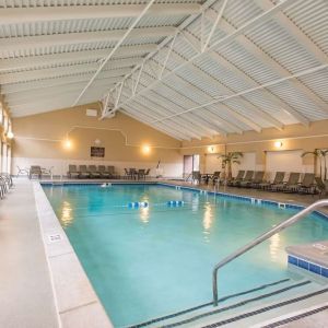 Refreshing indoor pool surrounded by loungers at DoubleTree By Hilton Grand Rapids Airport.