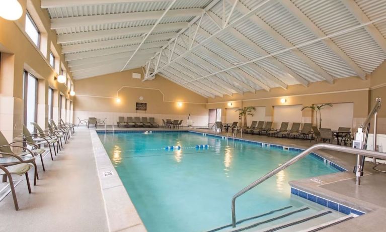 Refreshing indoor pool surrounded by loungers at DoubleTree By Hilton Grand Rapids Airport.