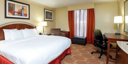Work desk and sofa in a king bedroom at DoubleTree By Hilton Grand Rapids Airport.