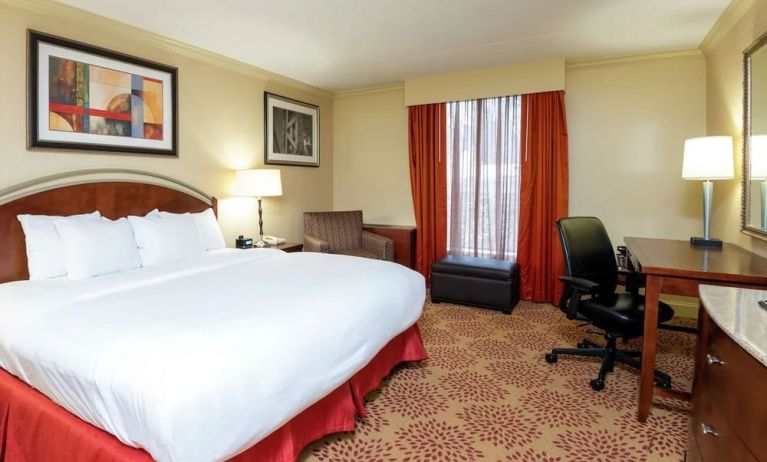 Work desk and sofa in a king bedroom at DoubleTree By Hilton Grand Rapids Airport.