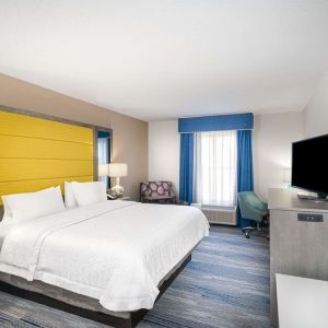 King size bed with work desk at Hampton Inn & Suites Amelia Island-Historic Harbor Front.