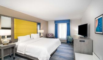 King size bed with work desk at Hampton Inn & Suites Amelia Island-Historic Harbor Front.