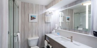 Guest bathroom with shower at Hampton Inn & Suites Amelia Island-Historic Harbor Front.