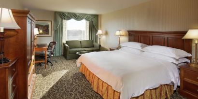 Spacious king room with king size bed, sofa and work desk at DoubleTree By Hilton Lisle-Naperville.