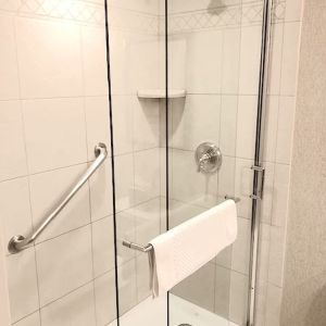 Guest bathroom with shower at DoubleTree By Hilton Lisle-Naperville.