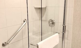 Guest bathroom with shower at DoubleTree By Hilton Lisle-Naperville.