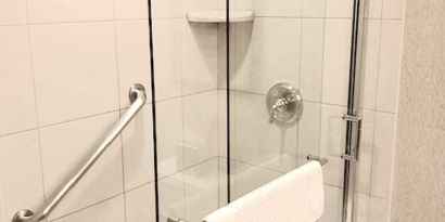 Guest bathroom with shower at DoubleTree By Hilton Lisle-Naperville.