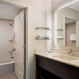 Private guest bathroom with combined shower and tub at Sonesta ES Suites Parsippany Morris Plains.