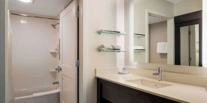 Private guest bathroom with combined shower and tub at Sonesta ES Suites Parsippany Morris Plains.
