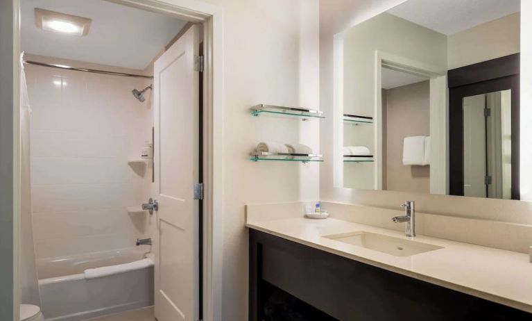 Private guest bathroom with combined shower and tub at Sonesta ES Suites Parsippany Morris Plains.