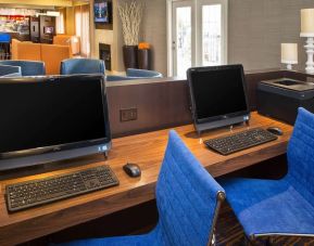 Business center with computers and ergonomic chairs at Sonesta Select Tinton Falls Eatontown.