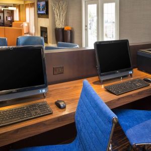 Business center with computers and ergonomic chairs at Sonesta Select Tinton Falls Eatontown.
