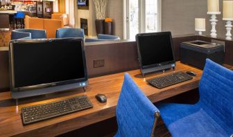 Business center with computers and ergonomic chairs at Sonesta Select Tinton Falls Eatontown.