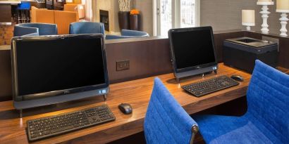 Business center with computers and ergonomic chairs at Sonesta Select Tinton Falls Eatontown.