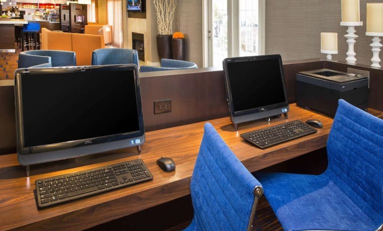 Business center with computers and ergonomic chairs at Sonesta Select Tinton Falls Eatontown.