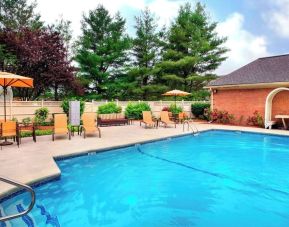 Outdoor pool with lounge seating at Sonesta Select Tinton Falls Eatontown.