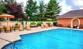 Outdoor pool with lounge seating at Sonesta Select Tinton Falls Eatontown.