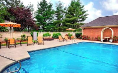 Outdoor pool with lounge seating at Sonesta Select Tinton Falls Eatontown.