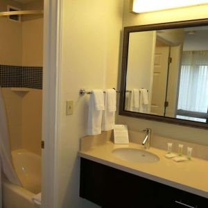 Private guest bathroom with combined shower and tub at Sonesta ES Suites Portland Vancouver 41st Street.
