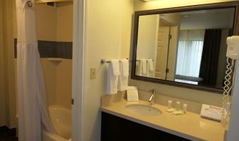 Private guest bathroom with combined shower and tub at Sonesta ES Suites Portland Vancouver 41st Street.