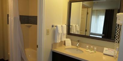 Private guest bathroom with combined shower and tub at Sonesta ES Suites Portland Vancouver 41st Street.