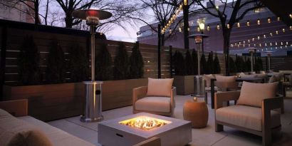 Patio with lounge seating and fire pit at Sonesta White Plains Downtown.