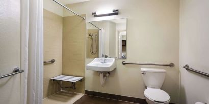 Accessible private guest bathroom with shower at Sonesta Simply Suites St Louis Earth City.