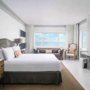 Bright and spacious day use room with workspace and lounge seating at Nautilus Sonesta Miami Beach.