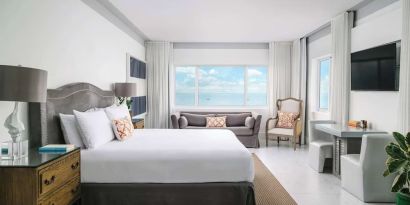 Bright and spacious day use room with workspace and lounge seating at Nautilus Sonesta Miami Beach.