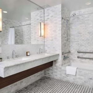 Private guest bathroom with combined shower and tub at Nautilus Sonesta Miami Beach.