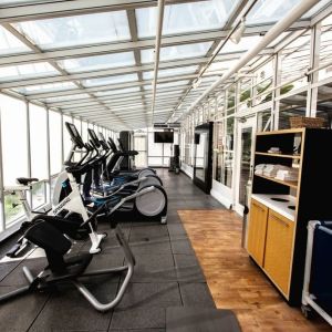 Fitness center with natural light at Embassy Suites By Hilton San Francisco Airport Waterfront.