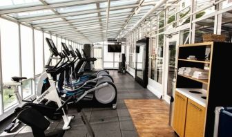 Fitness center with natural light at Embassy Suites By Hilton San Francisco Airport Waterfront.