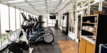 Fitness center with natural light at Embassy Suites By Hilton San Francisco Airport Waterfront.