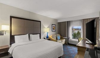 Comfortable king room with sofa and work desk at Hampton Inn Bloomington.
